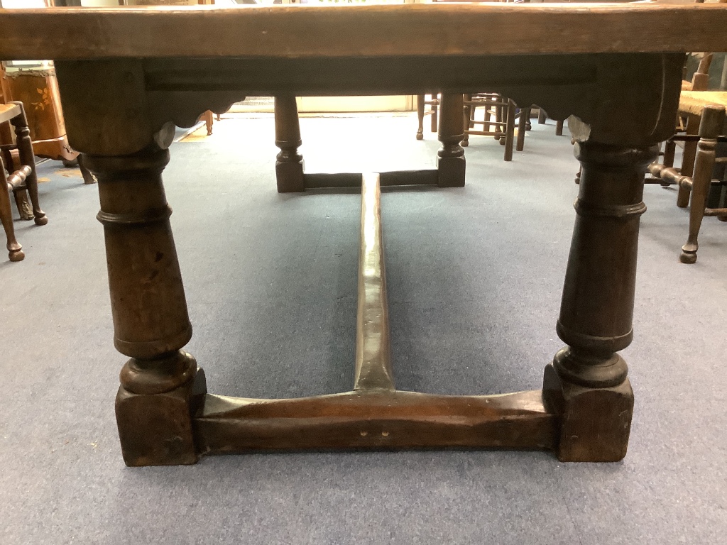 An 18th century style oak refectory dining table, length 274cm, width 94cm, height 72cm